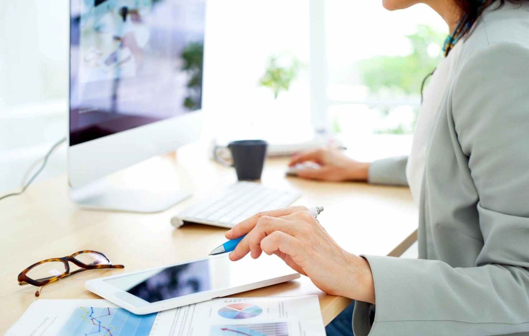 A person is using a tablet at a desk